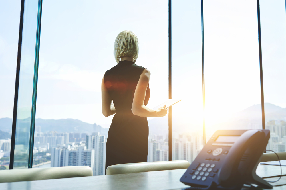 Back,View,Of,A,Businesswoman,With,Digital,Tablet,In,Hands